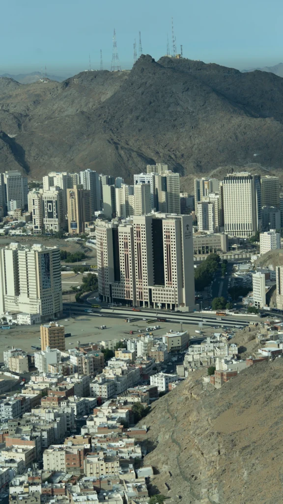 Aerial view of Makkah cityscape with Wirgan Hotel tower surrounded by mountains and city buildings